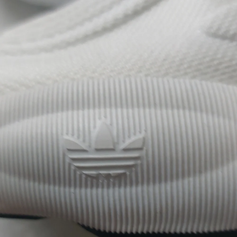 Adidas Adifom SLTN shoes in the Cloud White / SolarYellow / Blue Colorway